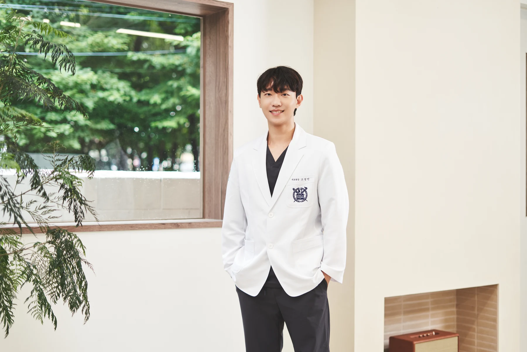 Ko Sungmin, Lead Director, standing by a window