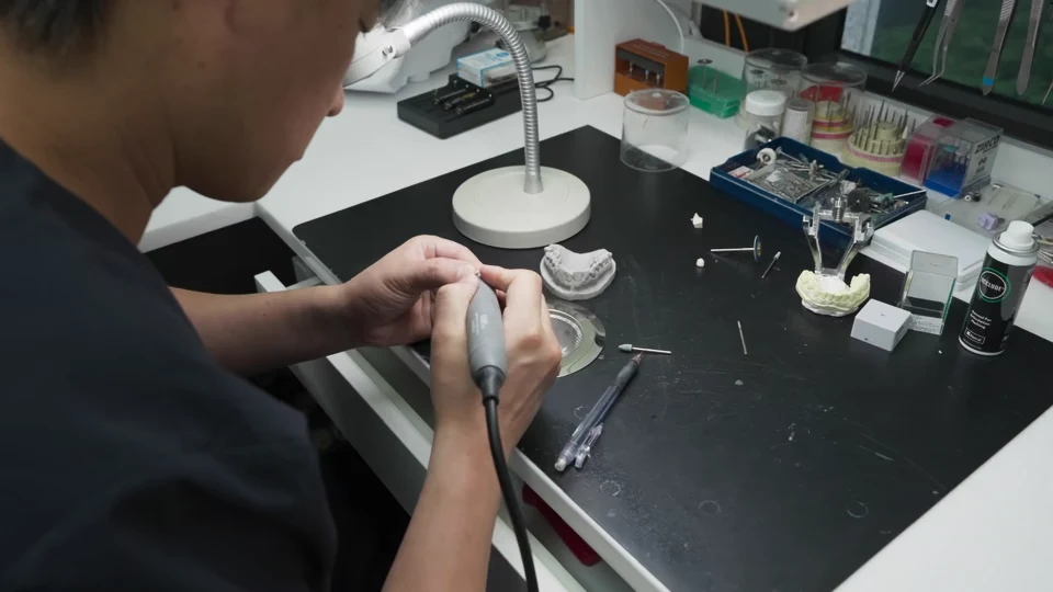 Laboratory manager Kim Byeonghee working on a restoration at his bench
